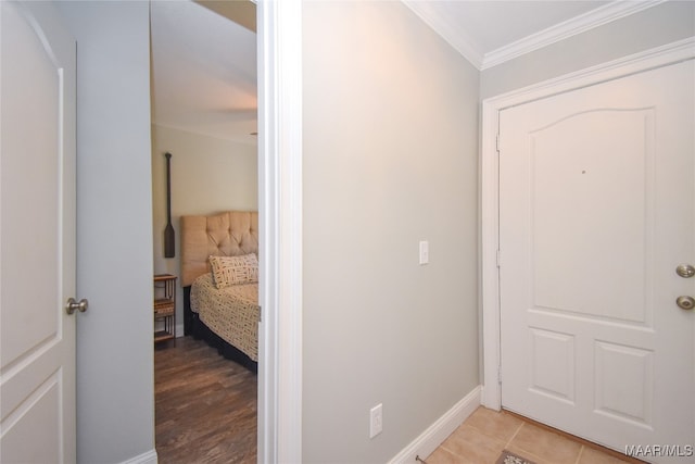 hall with ornamental molding and light hardwood / wood-style floors