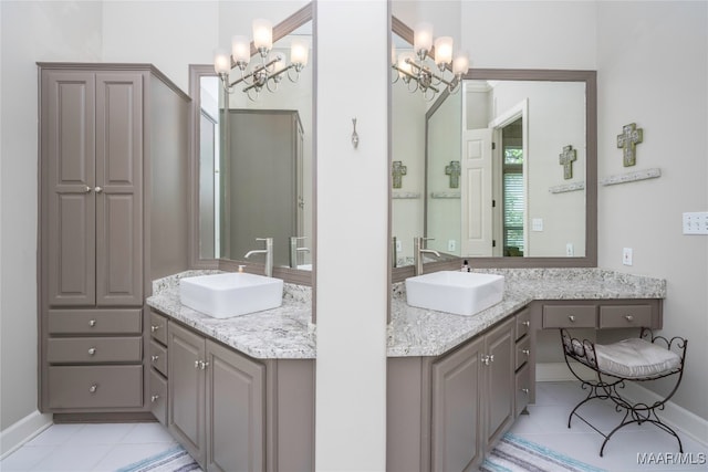 bathroom featuring vanity, a notable chandelier, and tile patterned floors