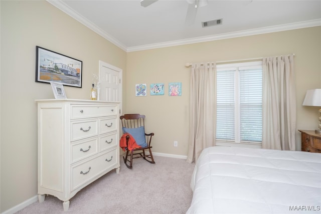 carpeted bedroom with ceiling fan and ornamental molding