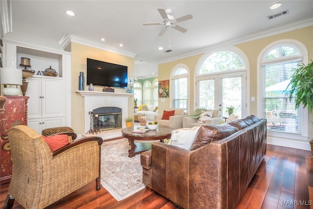 living room featuring ornamental molding, dark wood-type flooring, and ceiling fan