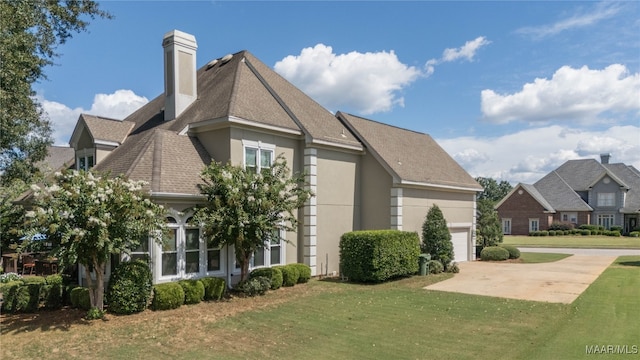 view of home's exterior with a yard and a garage