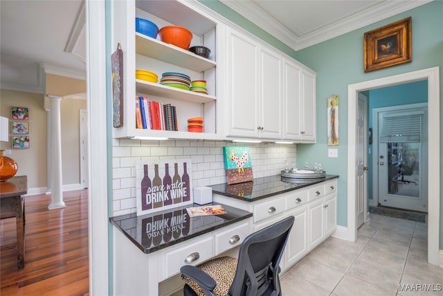 home office featuring crown molding, light wood-type flooring, and decorative columns