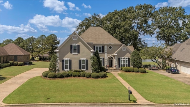 front of property with a garage and a front yard