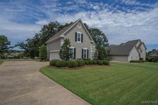 view of front of home with a garage and a front lawn