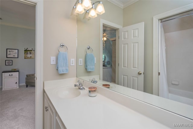 bathroom with shower / bath combo with shower curtain, crown molding, and vanity