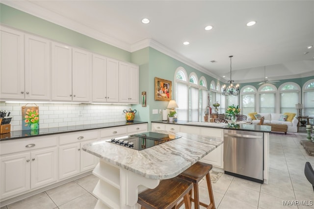 kitchen featuring decorative light fixtures, dishwasher, a center island, and sink