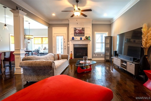 living room with decorative columns, ceiling fan, ornamental molding, and dark hardwood / wood-style floors