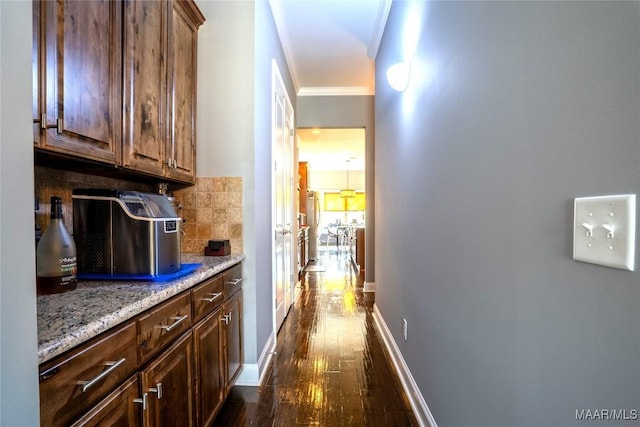 corridor featuring dark wood-type flooring and crown molding