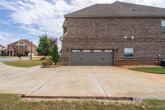 view of side of home featuring a garage