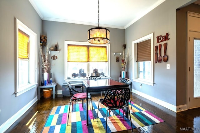 dining space featuring a healthy amount of sunlight, dark hardwood / wood-style flooring, ornamental molding, and a notable chandelier