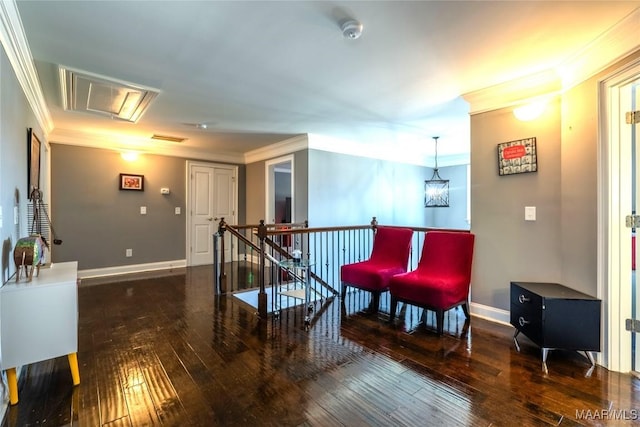 sitting room with dark hardwood / wood-style flooring, an inviting chandelier, and ornamental molding