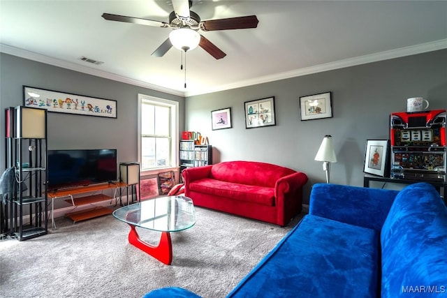 carpeted living room with crown molding and ceiling fan