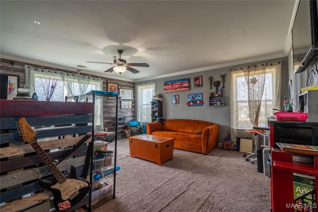 carpeted bedroom with multiple windows, ceiling fan, and crown molding