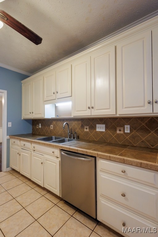 kitchen with light tile patterned floors, dishwasher, crown molding, sink, and decorative backsplash