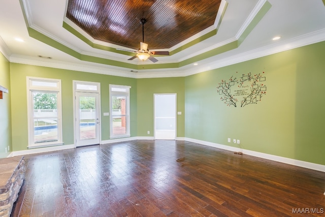 empty room featuring hardwood / wood-style floors, ceiling fan, a raised ceiling, and ornamental molding