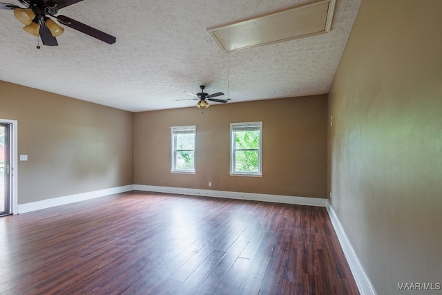 empty room featuring a textured ceiling, ceiling fan, and dark hardwood / wood-style floors