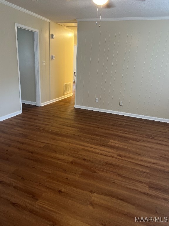 spare room featuring ornamental molding, a textured ceiling, ceiling fan, and dark hardwood / wood-style floors