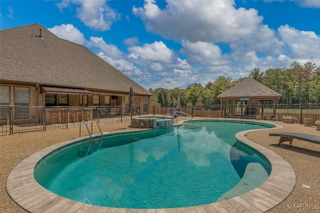 view of pool with an in ground hot tub and a patio area