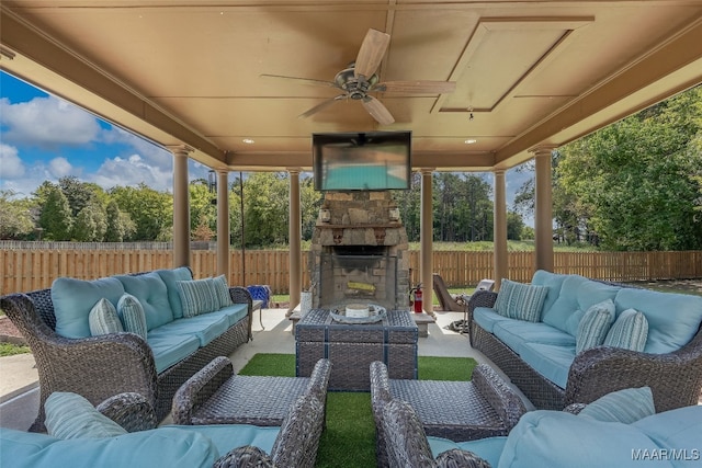 view of patio / terrace featuring an outdoor living space with a fireplace and ceiling fan