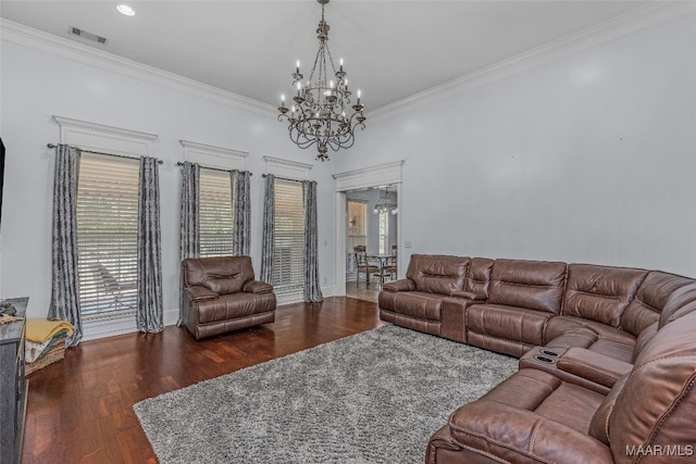 living room with dark wood-type flooring, ornamental molding, a chandelier, and a healthy amount of sunlight