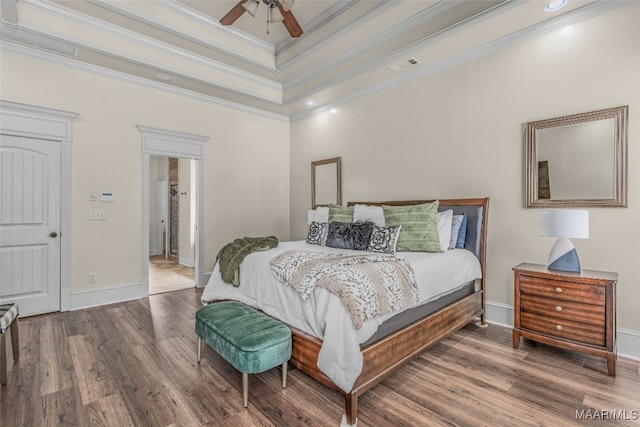 bedroom with ceiling fan, wood-type flooring, and ornamental molding