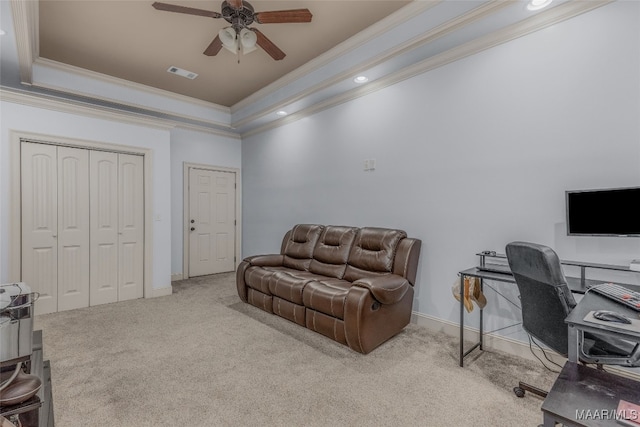 office area featuring ceiling fan, a raised ceiling, light carpet, and ornamental molding