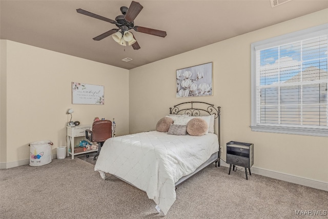 bedroom with ceiling fan and light carpet