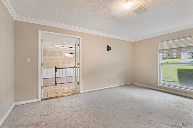 carpeted spare room featuring a textured ceiling, crown molding, and baseboards