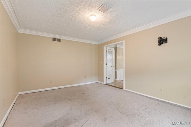 unfurnished room with visible vents, carpet, and ornamental molding