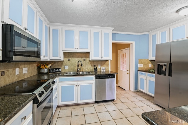 kitchen with sink, stainless steel appliances, white cabinets, crown molding, and light tile patterned floors