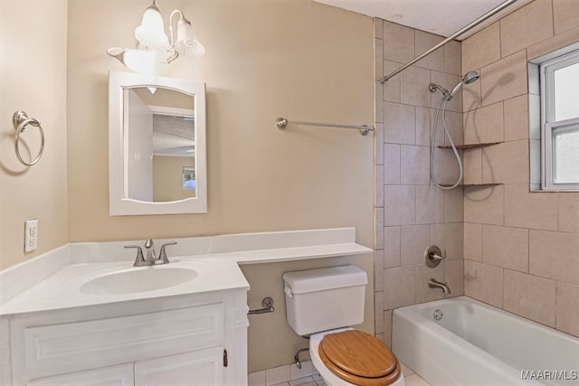 full bathroom featuring tile patterned floors, toilet, tiled shower / bath, vanity, and a chandelier