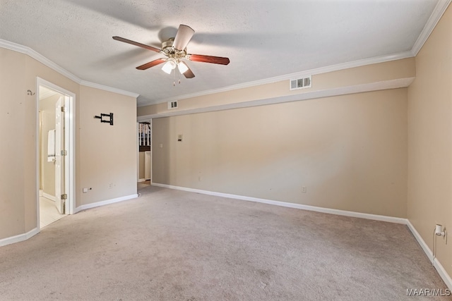 spare room featuring crown molding, light carpet, a textured ceiling, and ceiling fan