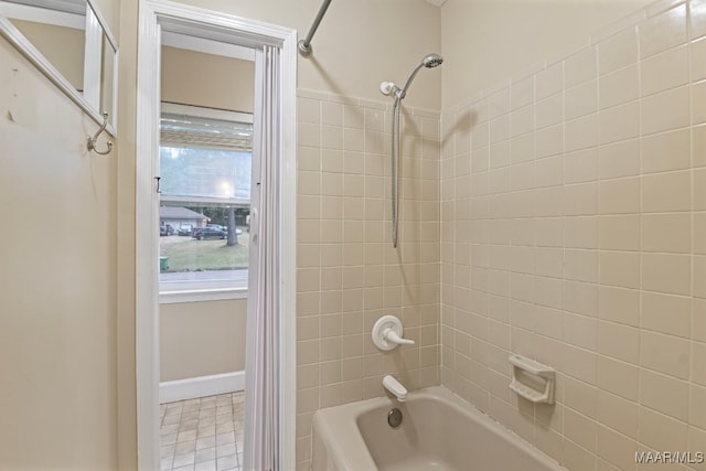 bathroom with tiled shower / bath and tile patterned flooring