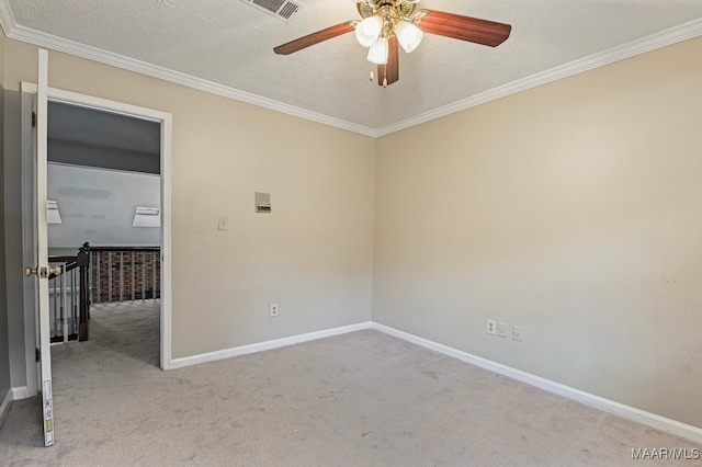 unfurnished room featuring light carpet, a textured ceiling, and ornamental molding