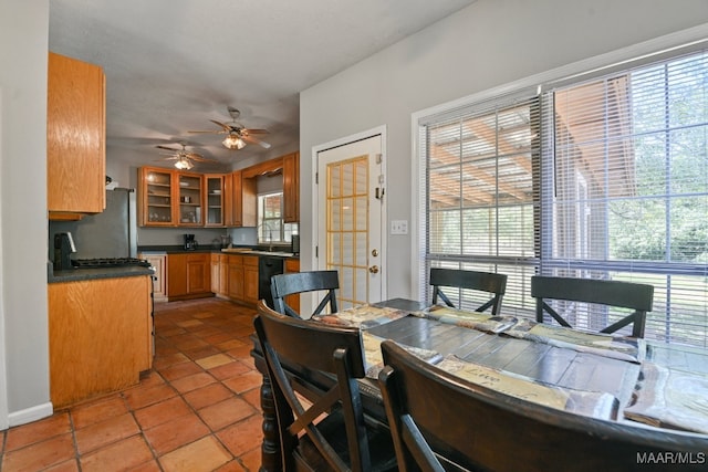 dining area featuring a wealth of natural light, light tile patterned floors, and ceiling fan