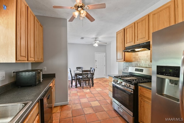 kitchen with a textured ceiling, light tile patterned floors, tasteful backsplash, stainless steel appliances, and ceiling fan