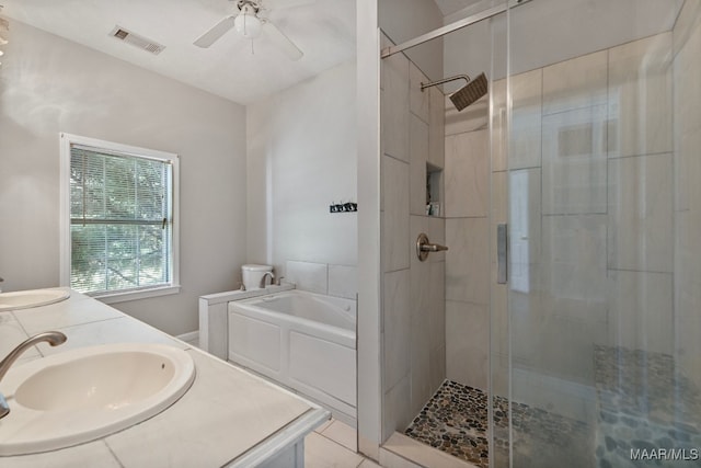 bathroom featuring ceiling fan, shower with separate bathtub, and vanity