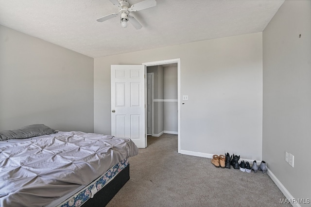 carpeted bedroom with lofted ceiling, ceiling fan, and a textured ceiling