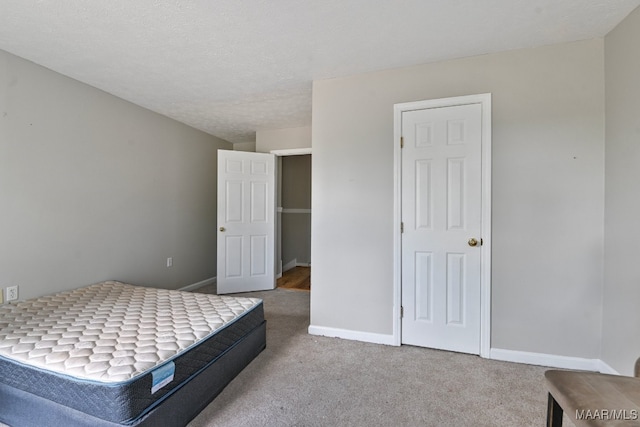 carpeted bedroom featuring a textured ceiling