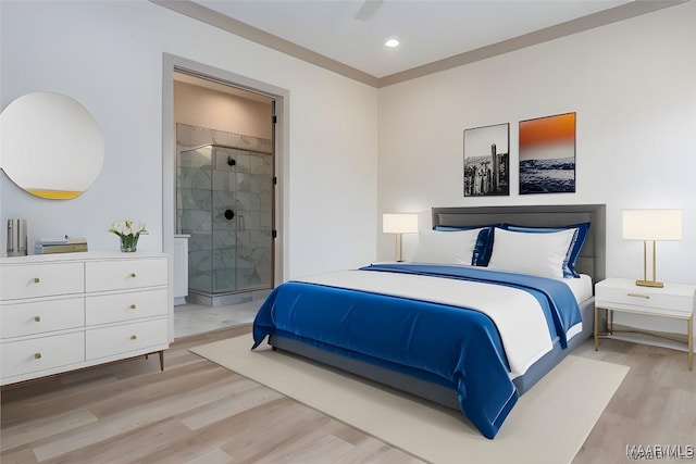 bedroom featuring connected bathroom and light wood-type flooring