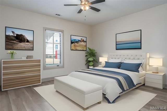 bedroom with ceiling fan and hardwood / wood-style floors