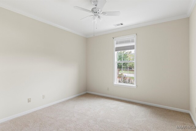 carpeted spare room featuring ceiling fan and crown molding