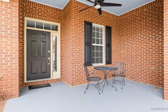 view of exterior entry featuring a patio and ceiling fan