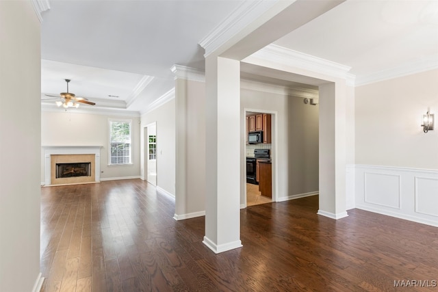 unfurnished living room featuring ornamental molding, ceiling fan, and dark wood-type flooring