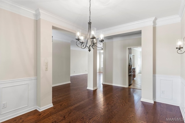 unfurnished dining area featuring an inviting chandelier, crown molding, and dark hardwood / wood-style flooring