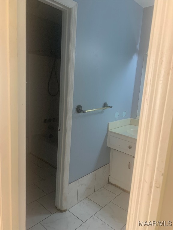 bathroom featuring a shower and vanity