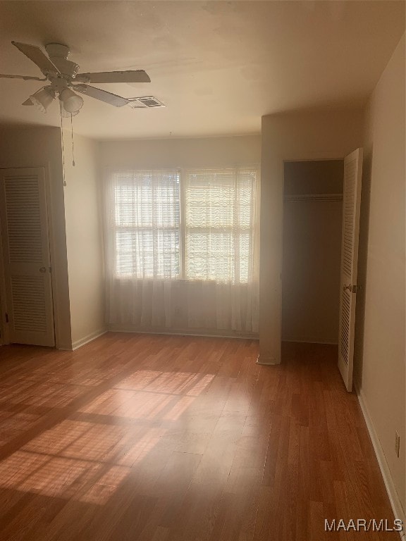 unfurnished bedroom with hardwood / wood-style floors and ceiling fan