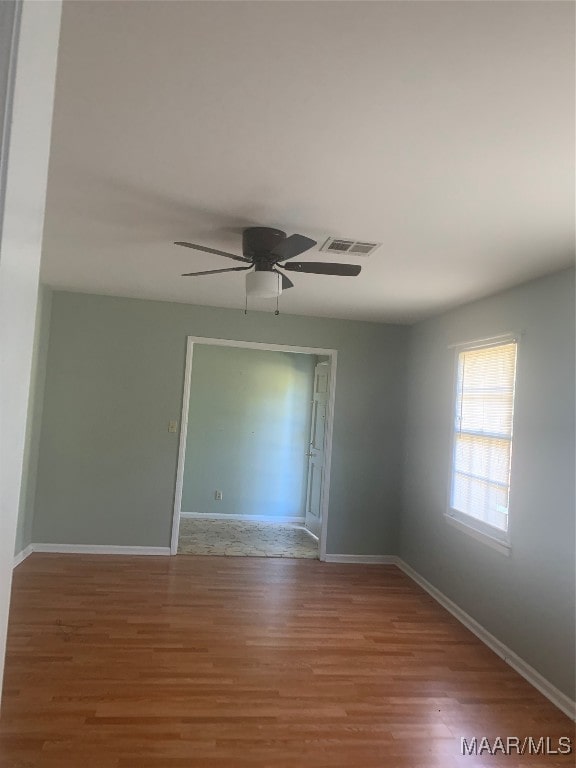 spare room featuring ceiling fan and wood-type flooring