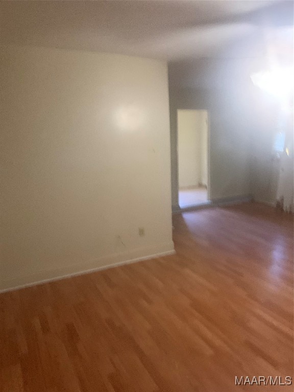 empty room with hardwood / wood-style flooring