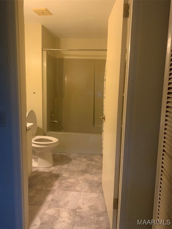 bathroom with toilet and shower / bath combination